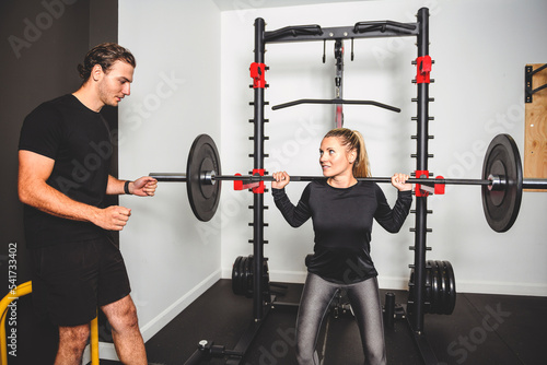 Woman with her personal fitness trainer at the gym