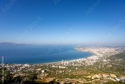 Attractive spring cityscape of Vlore city from Kanines fortress. Captivating sunset sescape of Adriatic sea. Spectacular outdoor scene of Albania, Europe. Traveling concept background.