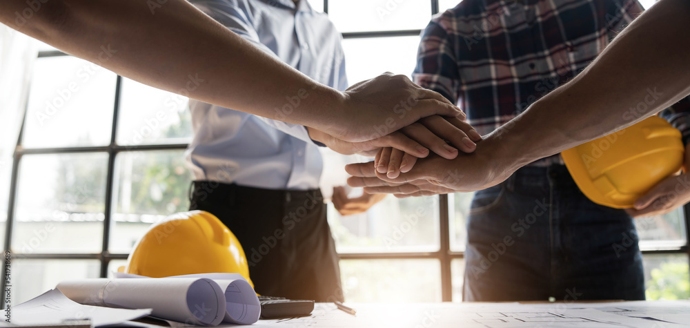 Team of engineer and architects working join hands to build successful projects. Teamwork concept. Team of engineer and architects working join hands to build successful projects. Teamwork concept.