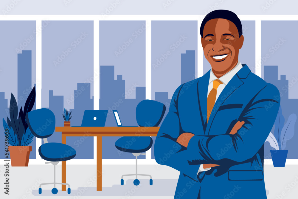 Black executive wearing blue suite and necktie standing in middle of his office cabin with arms crossed smiling