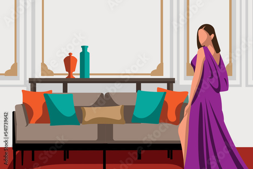 A female celebrity posing seductively sexy in front of a large sofa in her drawing room