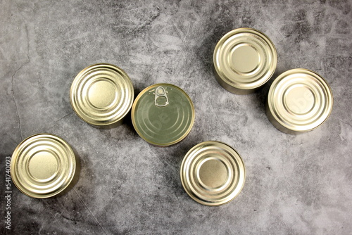 Tin cans on grey background, metal cans for fish and meat products