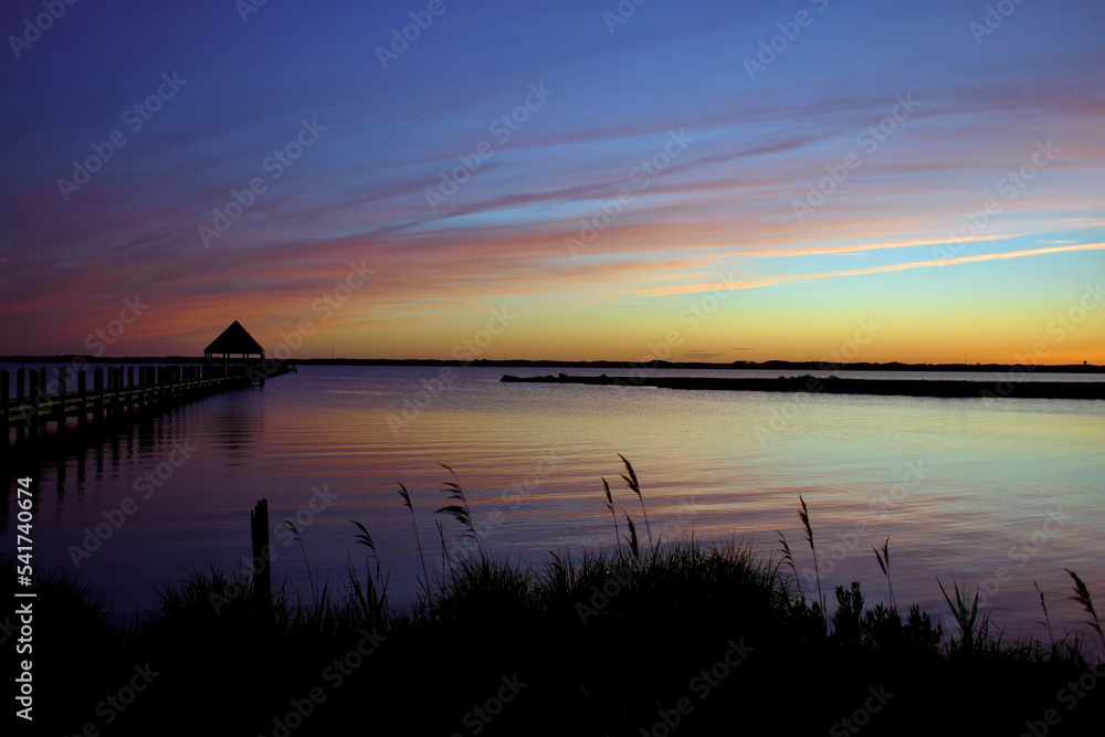 evening sunset image on the bay in Ocean City MD with blue,yellow and red skies