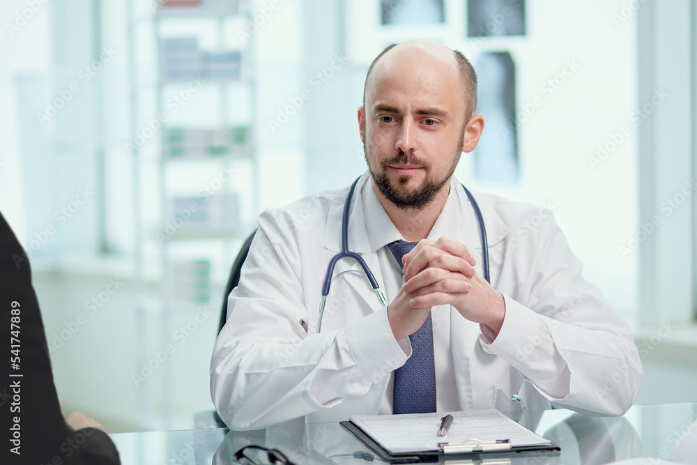 Fototapeta premium close-up. male doctor consults a patient in his office.