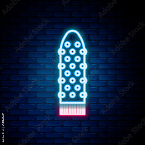 Glowing neon line Dildo vibrator for sex games icon isolated on brick wall background. Sex toy for adult. Vaginal exercise machines for intimate. Colorful outline concept. Vector