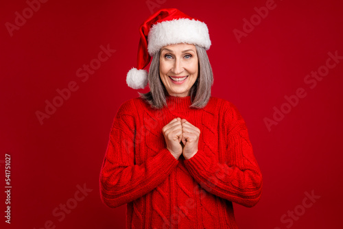 Photo of excited funny adorable grandma anticipate surprise atmosphere wear hat knitted sweater isolated red color background
