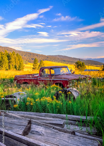 Abandoned Red Dodge Truck in Mountain Valley with Mountains in Background