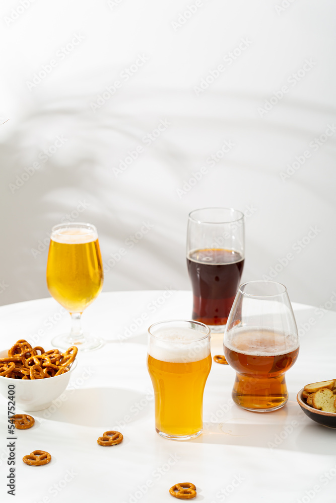 Glasses light and dark beer fand snacks in bowl food and drink copy space Glasses light and dark beer fand snacks in bowl food and drink copy space