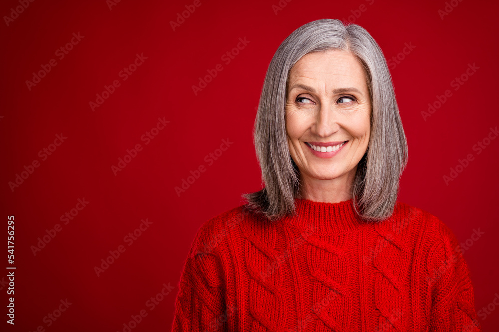 Photo of dreamy inspired thoughtful grandmother look empty space wear knitted pullover isolated red color background Photo of dreamy inspired thoughtful grandmother look empty space wear knitted pullover isolated red color background