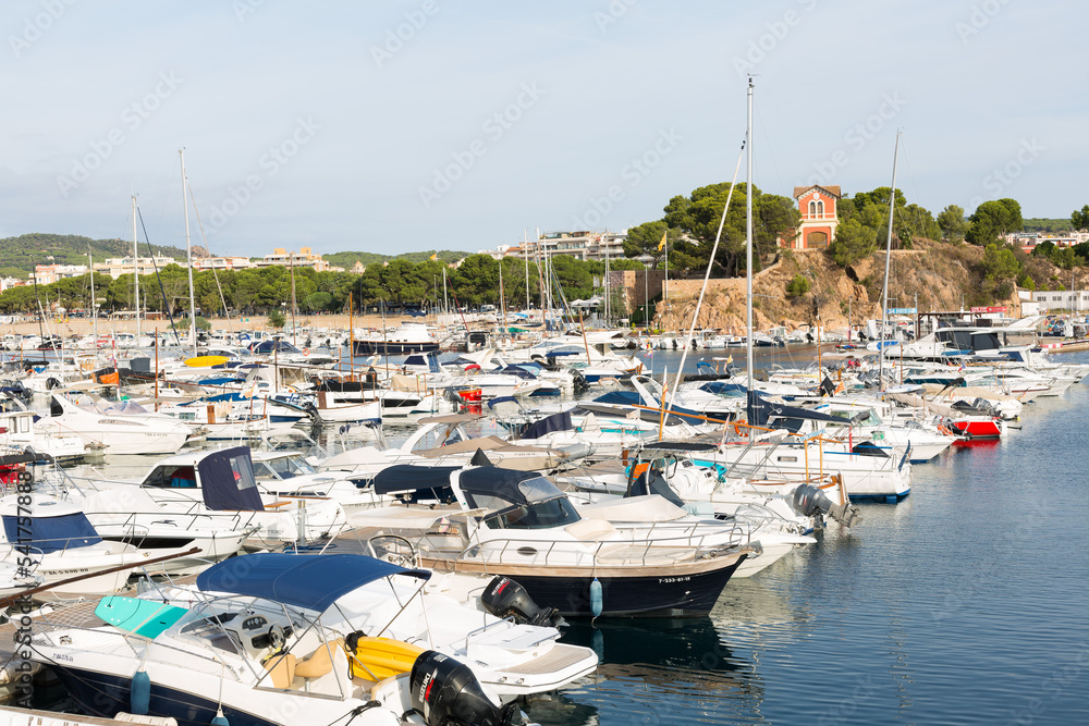 Marina with small boats moored at the quay in Sant Feliu de Gixols, Catalonia, Spain