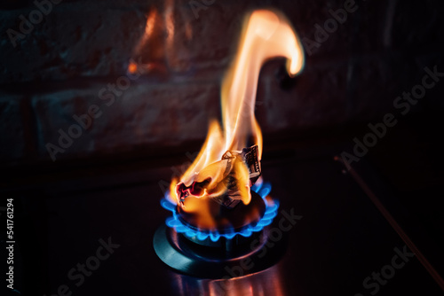 Energy crisis after Russias invasion of Ukraine. Increase the cost of supply, payment for natural gas. Paper banknote burns like fuel on gas stove burner in the kitchen