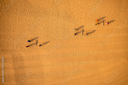 Aerial view of farmers working in a field drying rice on a rice field in Dhamrai, Dhaka, Bangladesh. photo