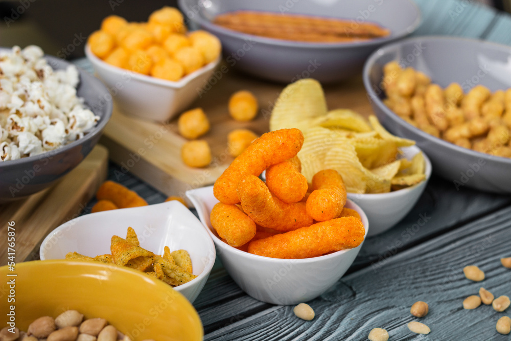 Beer salty snacks on wooden table