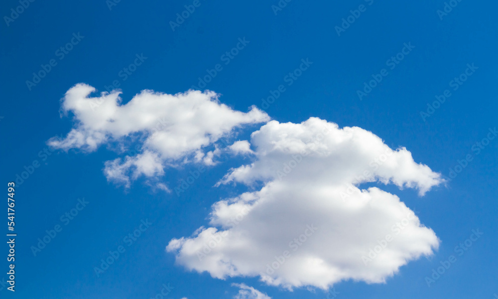 Summer sky. Cumulus clouds on a blue background. Partly cloudy. Summer sky. Cumulus clouds on a blue background. Partly cloudy.