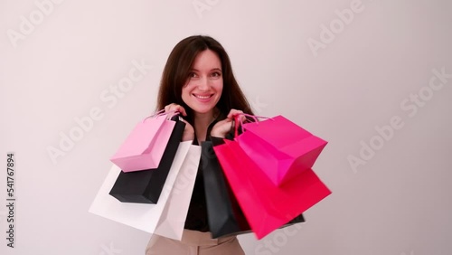 Black friday concept. Smiling woman holding a paper shopping bags and enjoys shopping