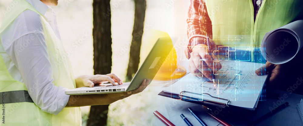 Obraz premium Construction engineer working at blueprint to build large commercial buildings in office. Engineering tools and construction concept.