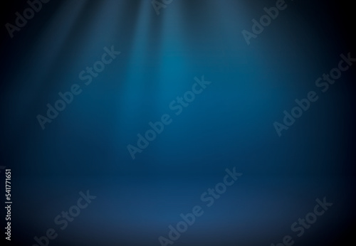 Blue studio scene background. Neutral background with soft rays. Soft studio lighting. Photostudio soft box lighting.