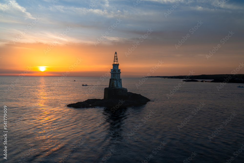 view of the small harbor lighthosue in Athopol on the Black Sea coast of Bulgaria at sunrise