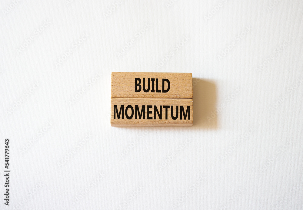 Build momentum symbol. Wooden blocks with words Build momentum. Beautiful white background. Business and Build momentum concept. Copy space.