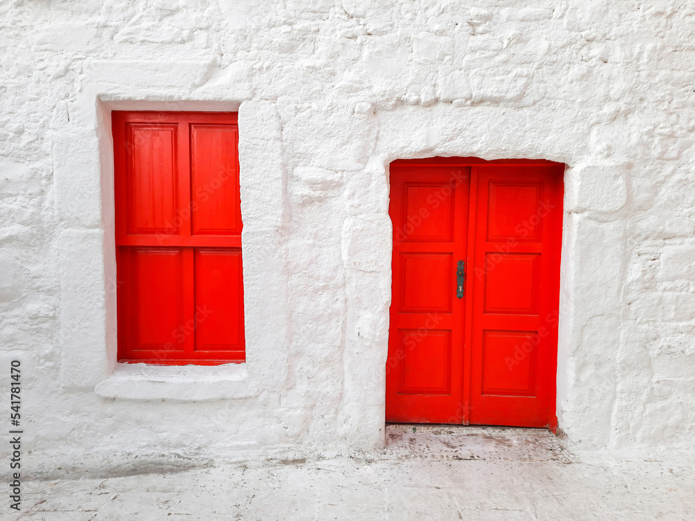 Door and window with closed shutters of red color in a house with white walls, Turkish building, national colors.. Door and window with closed shutters of red color in a house with white walls, Turkish building, national colors..