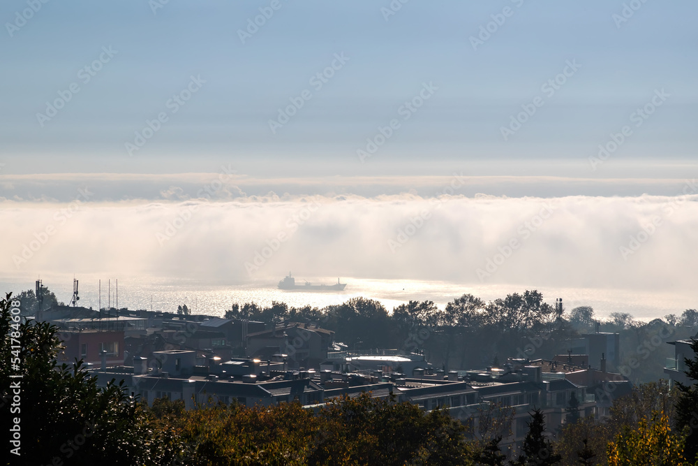 Fog clouds over the sea with a ship