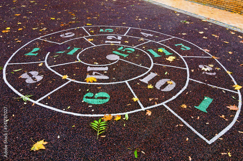 Snail Hopscotch (or Escargot)  Street Children's Game. Hopscotch drawn on the asphalt in the city park. Open air game for children in the park. Autumn in the Saint Volodymyr Hill in Kyiv, Ukraine
