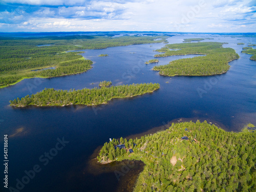 Aerial view of islands and traditional wooden houses on shore of Inari lake, Finland