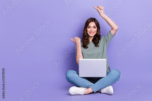 Photo of positive pretty lady stylish clothes two arm above head direct empty space offer sale shopping isolated on purple color background © deagreez