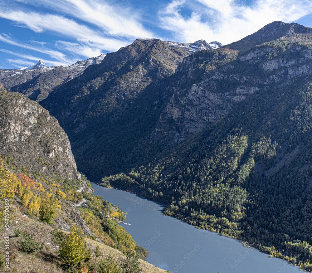 View of Lac du Chambon resrvoir below with beautiful autumn fall colors in the foreground, near Mizoen village in Isere, Rhyone-Alpes, France