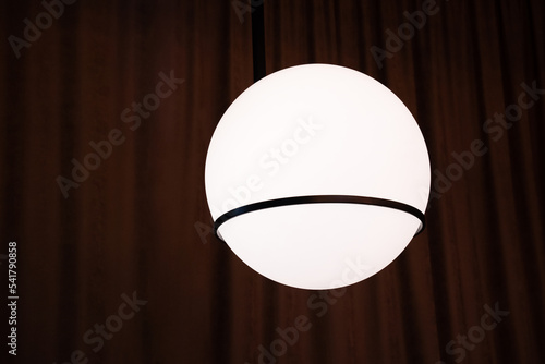 a lamp in the form of a ball on a dark background. abstraction planet