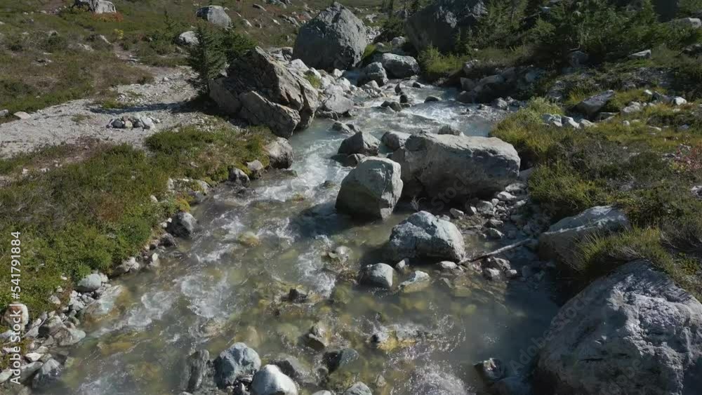 River and waterfall with green trees in Canadian Mountain Landscape. Brandywine Meadows near Whistler and Squamish, British Columbia, Canada. Nature Background. Aerial Cinematic River and waterfall with green trees in Canadian Mountain Landscape. Brandywine Meadows near Whistler and Squamish, British Columbia, Canada. Nature Background. Aerial Cinematic