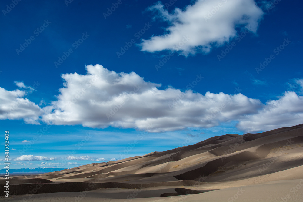 Amazing view to the Great Sand Dunes.. Dunes ant clouds in the sky. Very colorful landscape Amazing view to the Great Sand Dunes.. Dunes ant clouds in the sky. Very colorful landscape