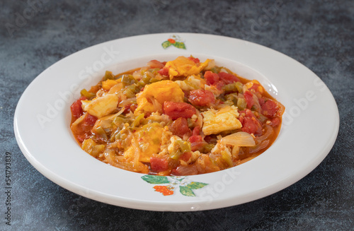Traditional turkish food menemen made by eggs and tomatoes.
