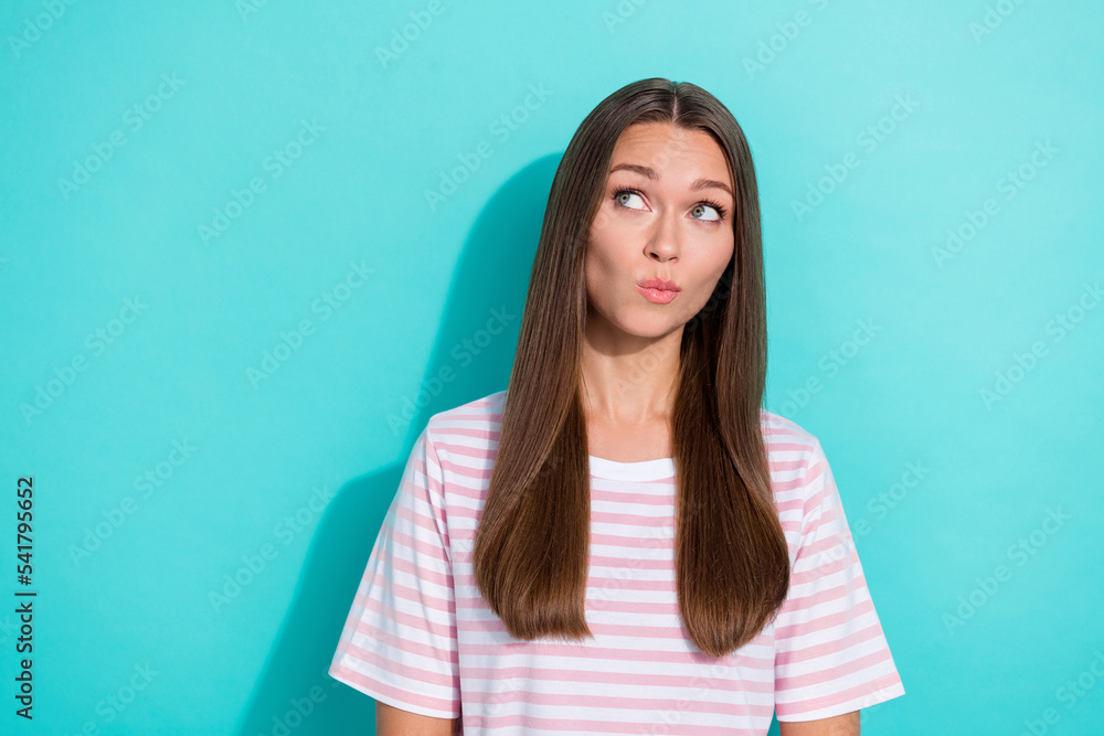 Fototapeta premium Photo of thoughtful minded girl with long hairstyle wear striped t-shirt dreaming look empty space isolated on turquoise color background