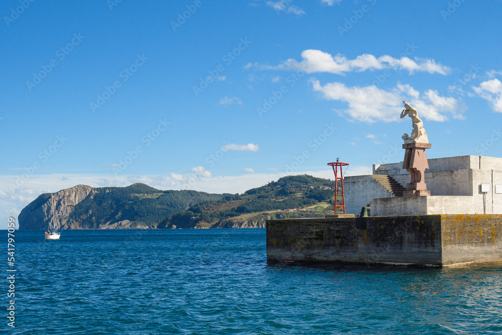 Entrance to the port of Bermeo with Xixili, the lamia that watches over the port