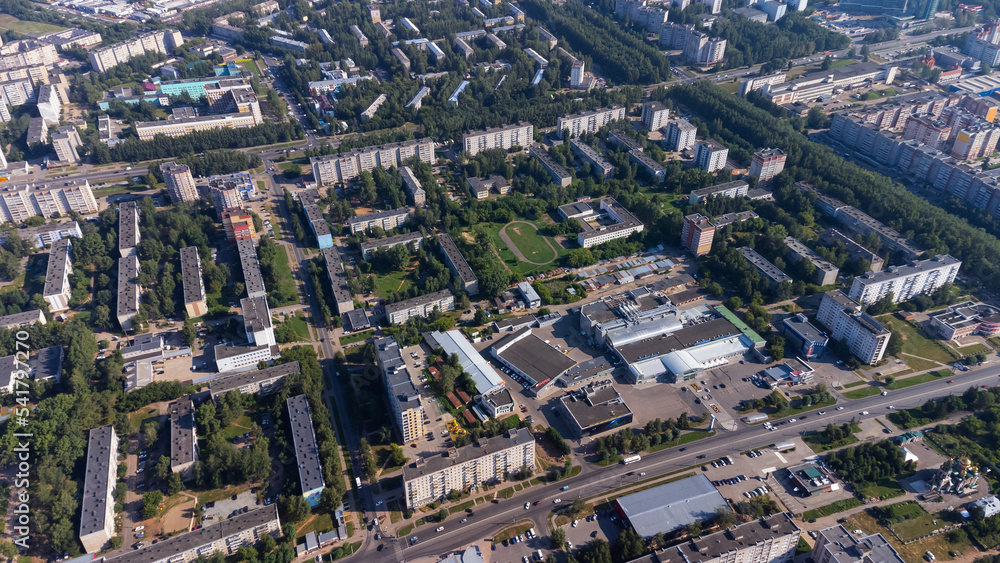 Naklejka premium City, locality. Construction site, residential area on a sunny summer day. Apartment buildings, high-rise buildings. The view from the drone, from above.