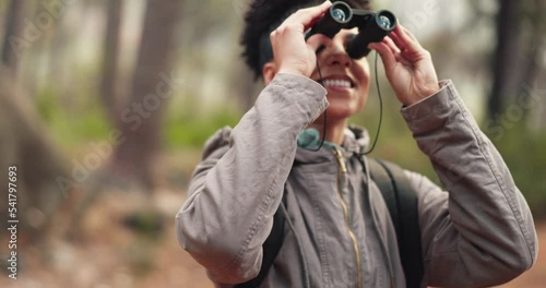 Travel, adventure and binocular hiking in nature forest for exercise and trekking journey holiday. Happy female outdoor by tree for fitness workout, freedom and health on woods bird watching vacation