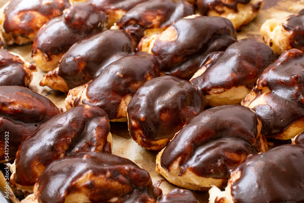 Fototapeta premium Many home made eclairs covered with chocolate,