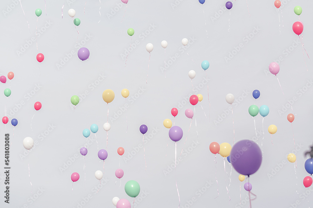 Lots of balloons flown through the sky with pastel shades
