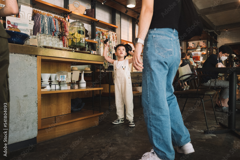 Little asian boy in cafe