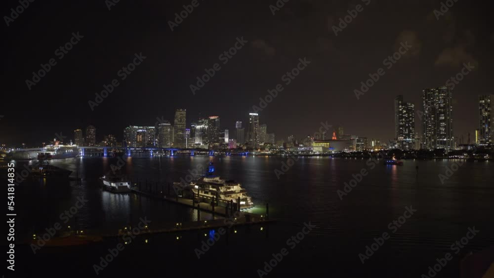 Aerial Lockdown Shot Of Nautical Vessels At Harbor In Financial District At Night - Miami, Florida Aerial Lockdown Shot Of Nautical Vessels At Harbor In Financial District At Night - Miami, Florida