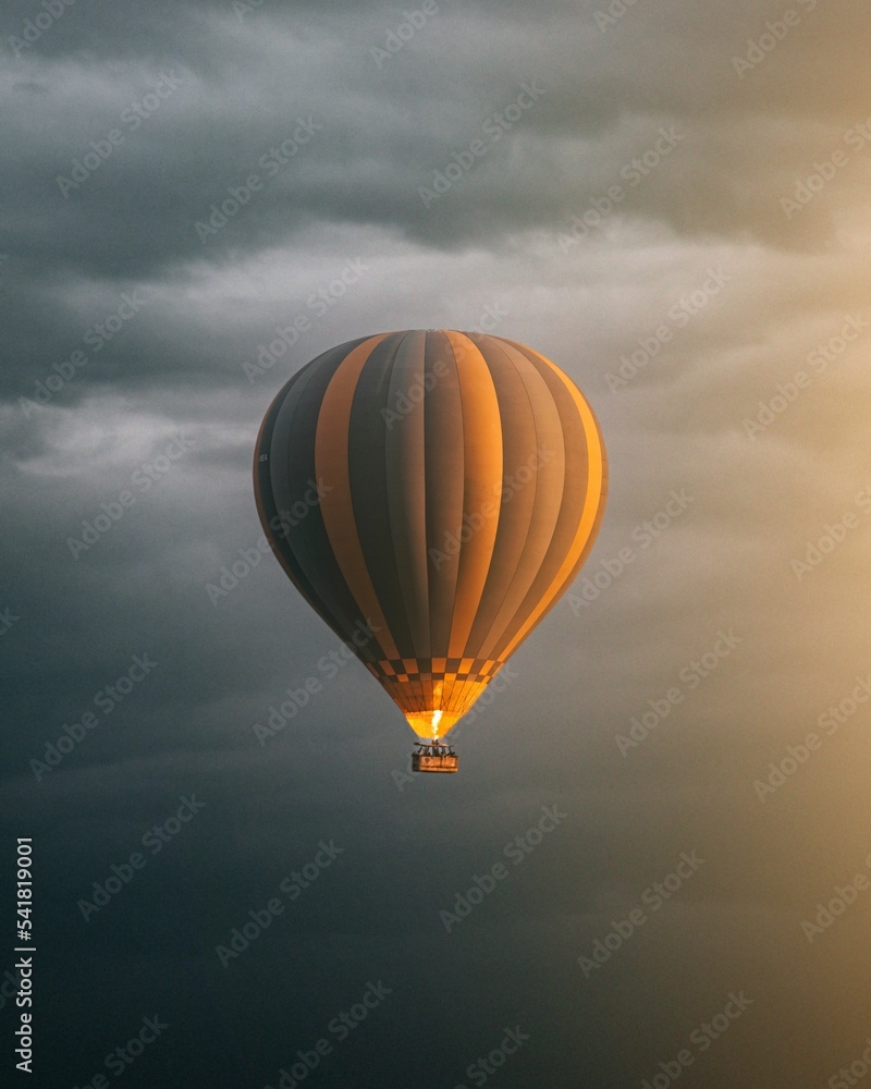 Vertical shot of a hot air balloon flying in the sky Stock Photo ...