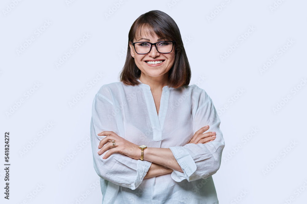 Positive middle aged woman looking at camera on white studio background Positive middle aged woman looking at camera on white studio background