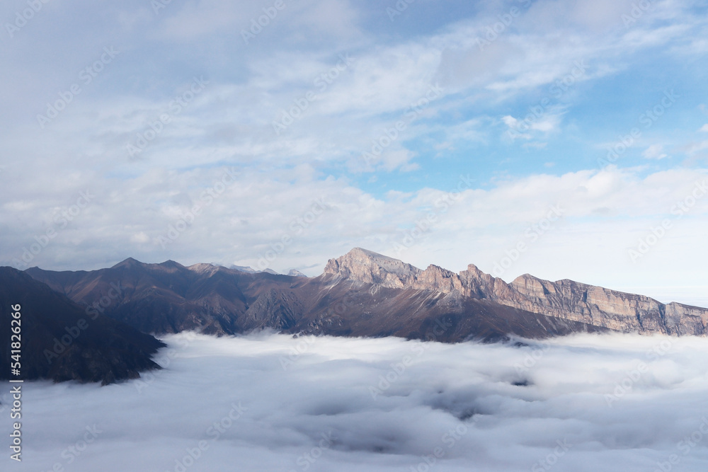 Mountain valley covered with clouds. Wilderness hike. The beauty of nature in hard-to-reach places. Caucasus