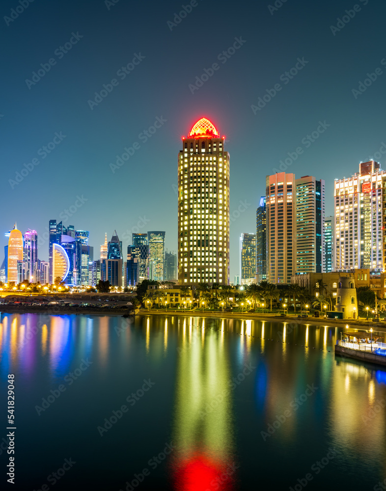 Vertical shot of Doha city illuminated with colorful lights, Doha