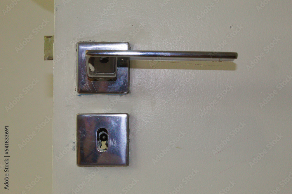 Lock and door handle made of silver metal Lock and door handle made of silver metal