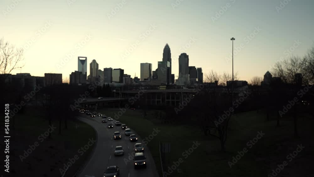 Lockdown Shot Of Illuminated Cars Moving On Roads In Residential City Against Clear Sky At Dusk - Charlotte, North Carolina Lockdown Shot Of Illuminated Cars Moving On Roads In Residential City Against Clear Sky At Dusk - Charlotte, North Carolina