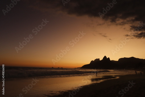 Rio de Janeiro  RJ  Brazil  2022 - People walking in silhouette at Ipanema Beach at sunset