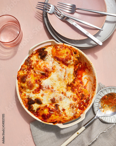 Baked lasagna in white round casserole dish