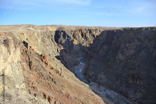 The Charyn River in a rocky deep canyon against the sky in spring in sunny weather